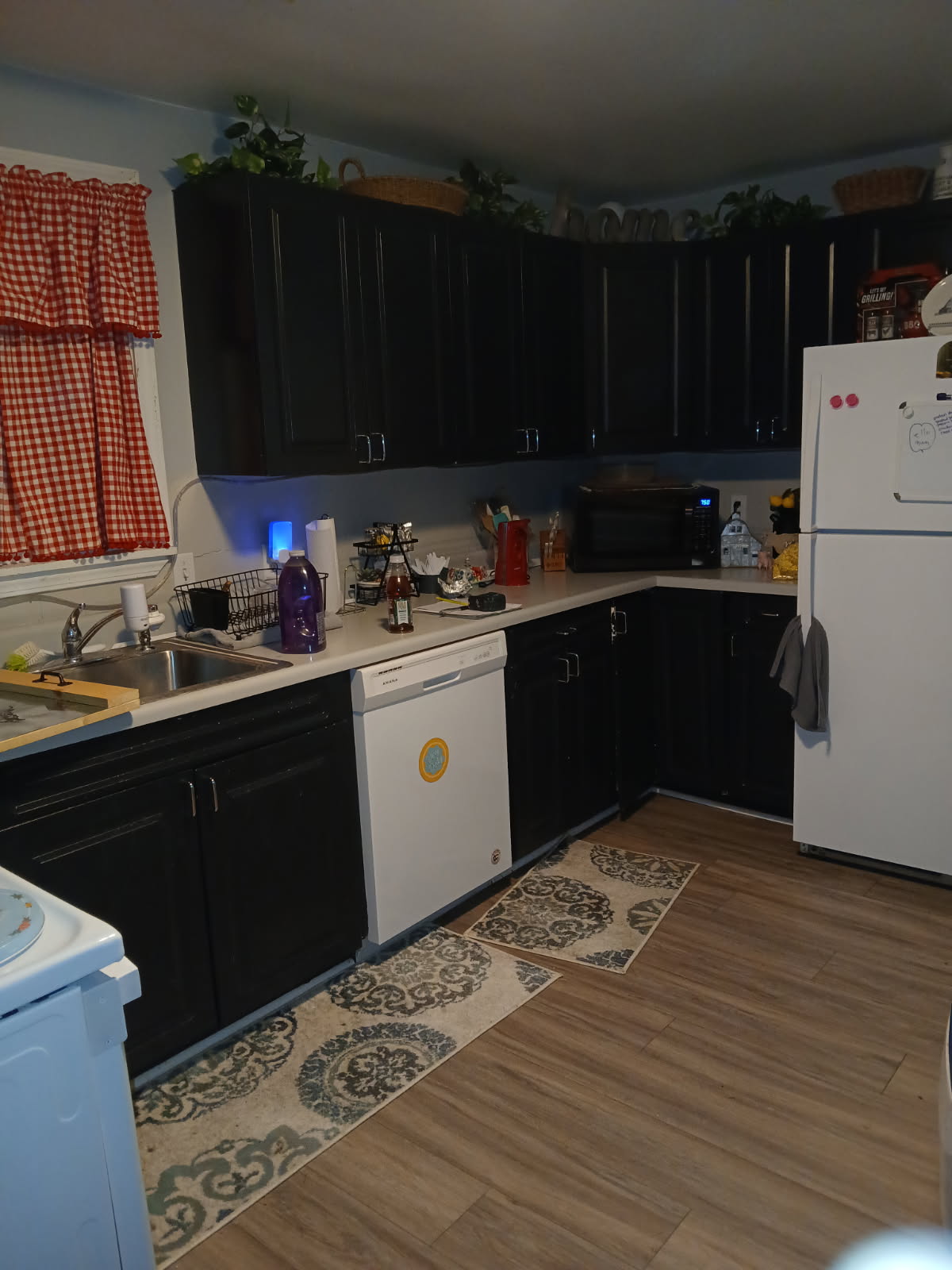 Kitchen before remodel showing outdated dark cabinets in Kirksville MO